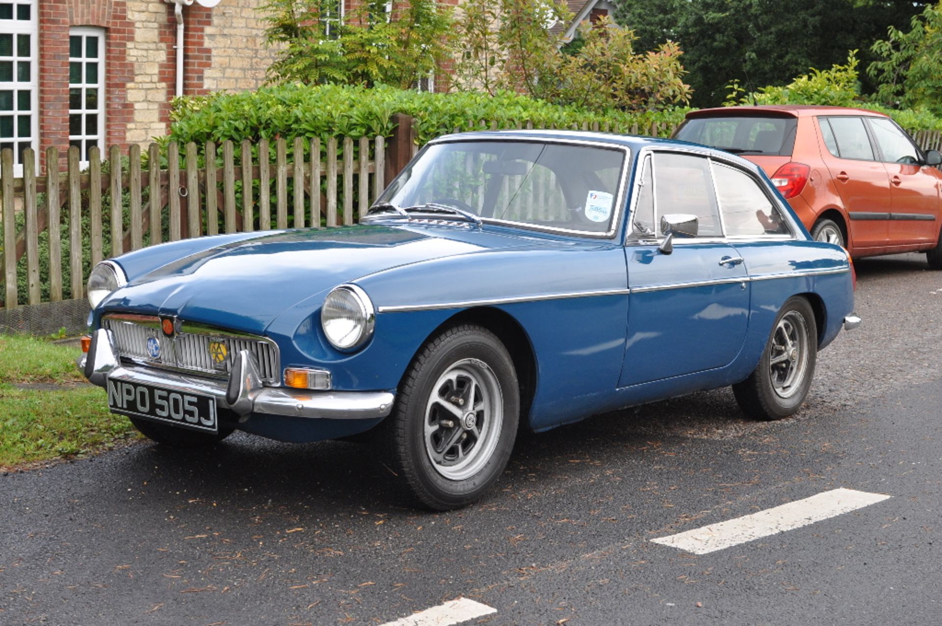 A 1971 MG B GT, registration number NPO 505J, teal blue.