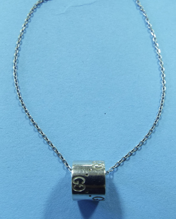 A Gucci 18ct white gold pendant, on an 1