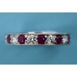 A diamond and ruby eternity ring, in a w