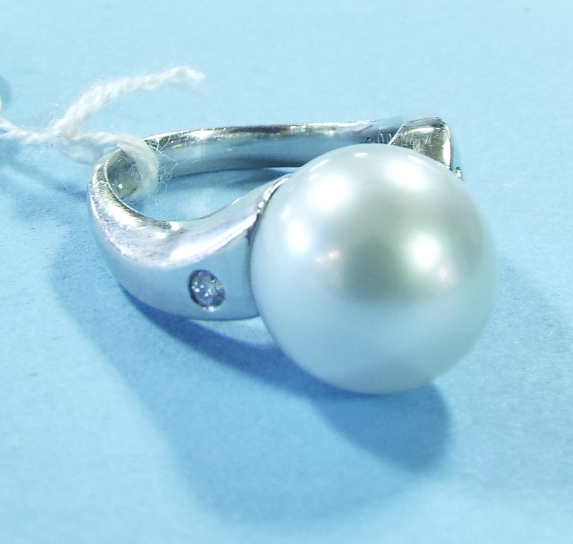 A platinum, pearl and diamond ring