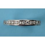 A diamond eternity ring, in a white colo