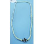 A graduated single strand pearl necklace