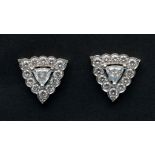 A pair of diamond stud earrings, the cen