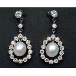 A pair of pearl and diamond drop earring