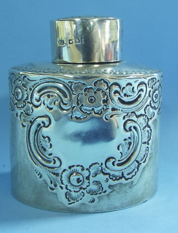 An oval silver tea caddy, initialled, an