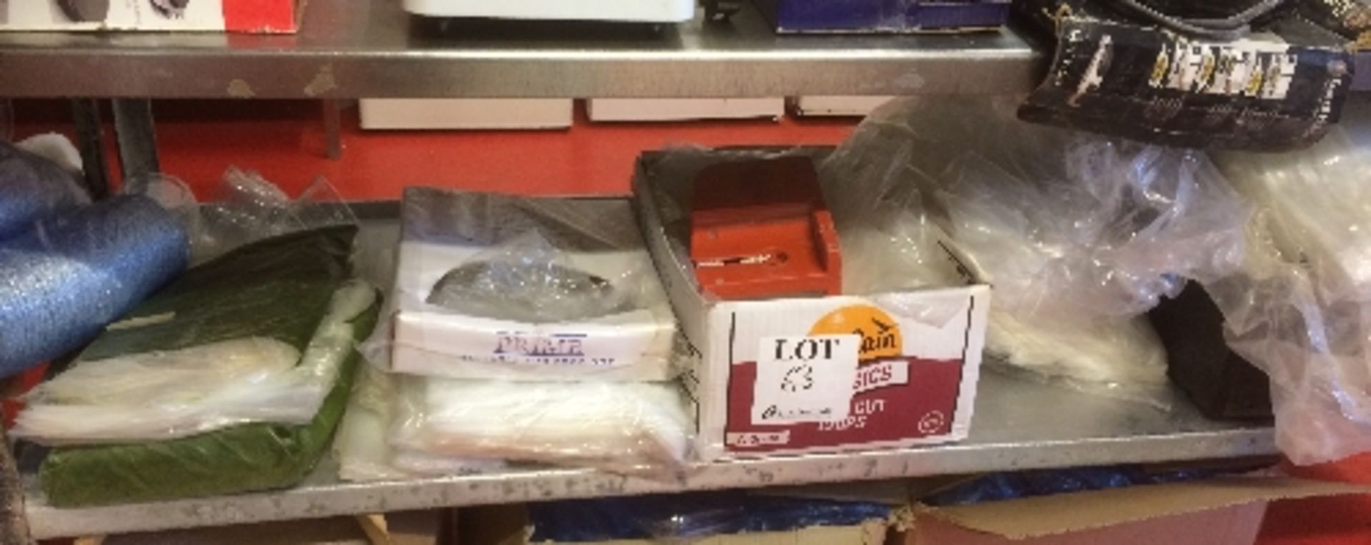 Shelf containing quantity of various sizes of cellophane food packaging bags