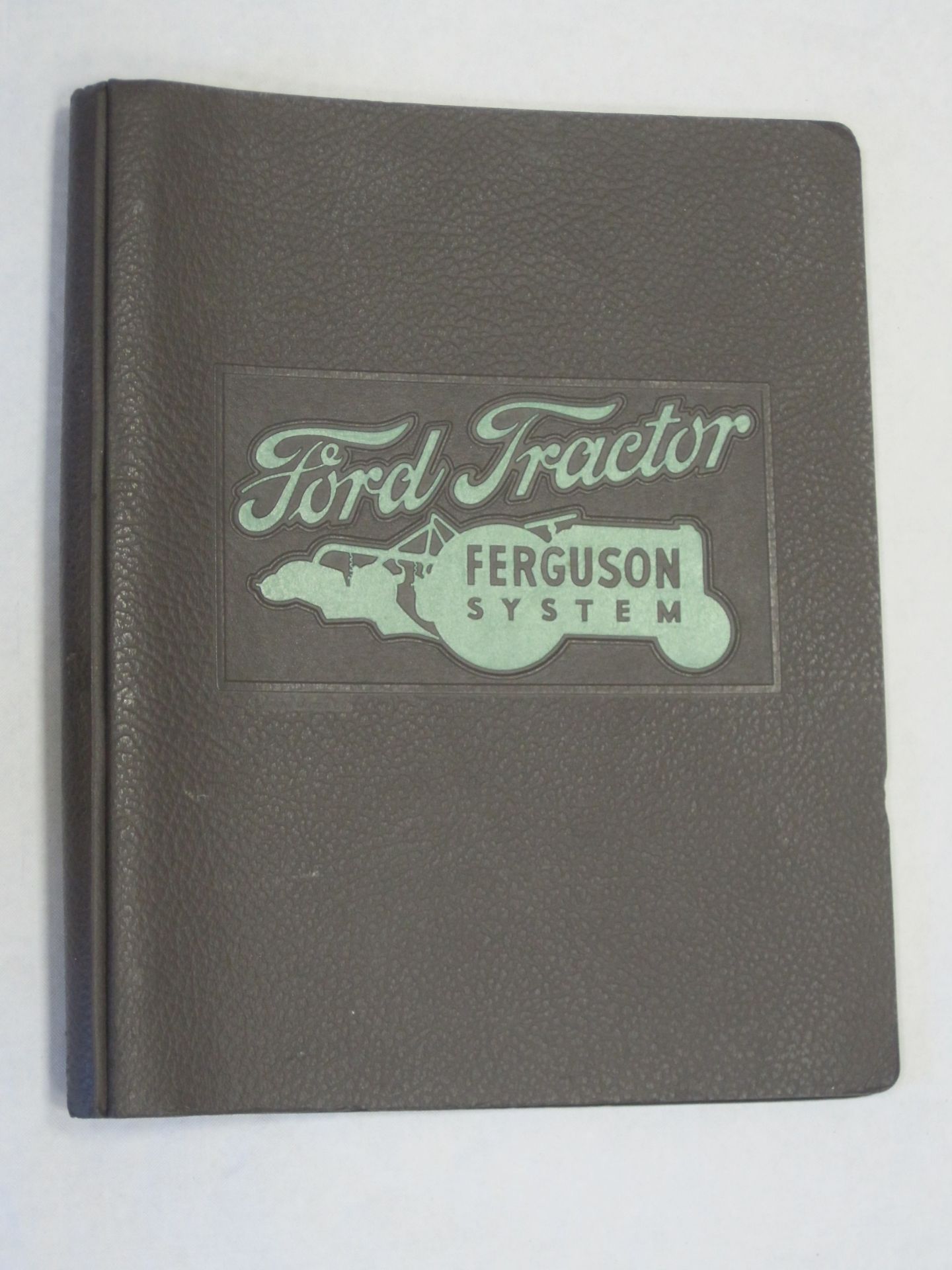 Ford Tractor Ferguson System; an embossed folder containing brochure for all purpose cultivator,