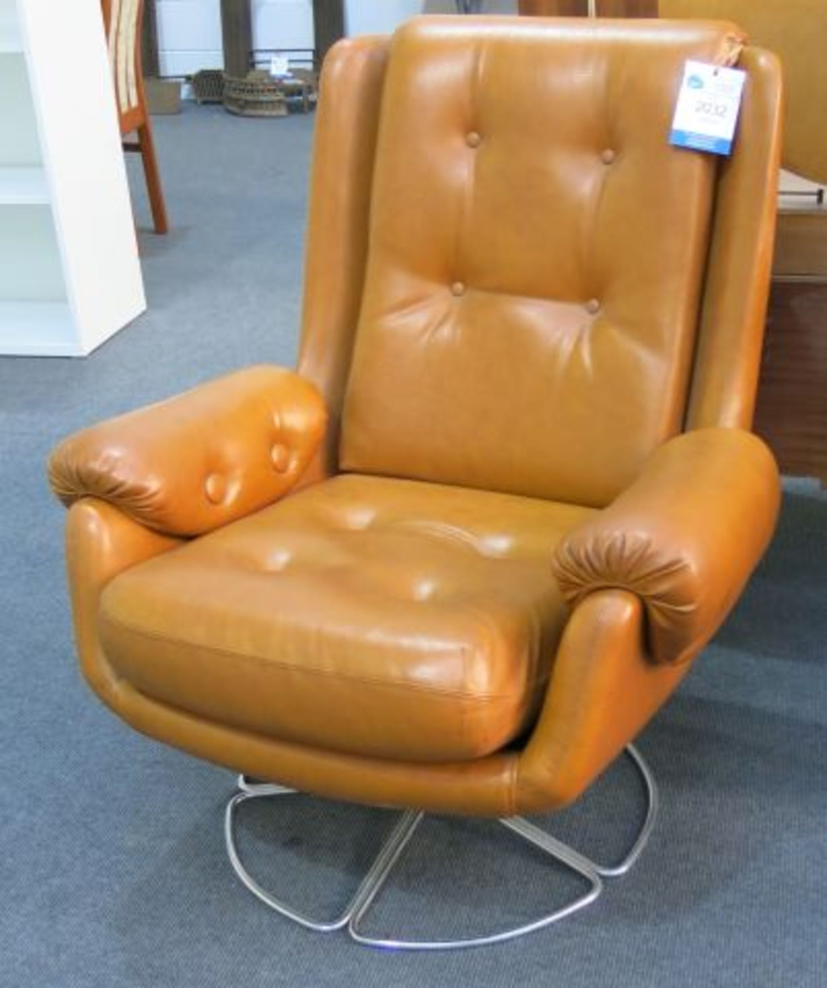 A Swivel Tan Leather Chair on Chrome Support. This Chair must not be used in a Domestic Environme