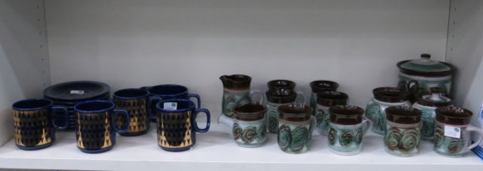 Twelve pieces of green & brown Glazed Stoneware with four blue and gold Hornsea Mugs with 8 blue