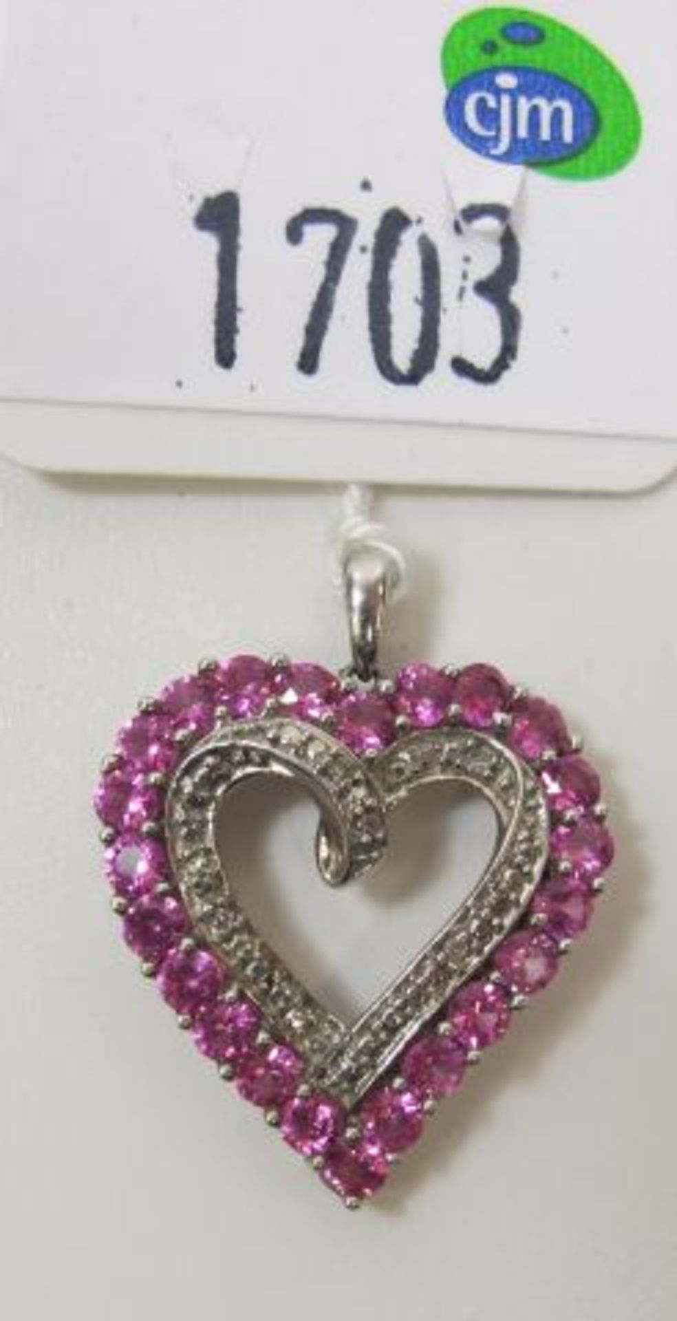 A 10ct White Gold Heart Shaped Ruby and Diamond Pendant (est. £20-£40)
