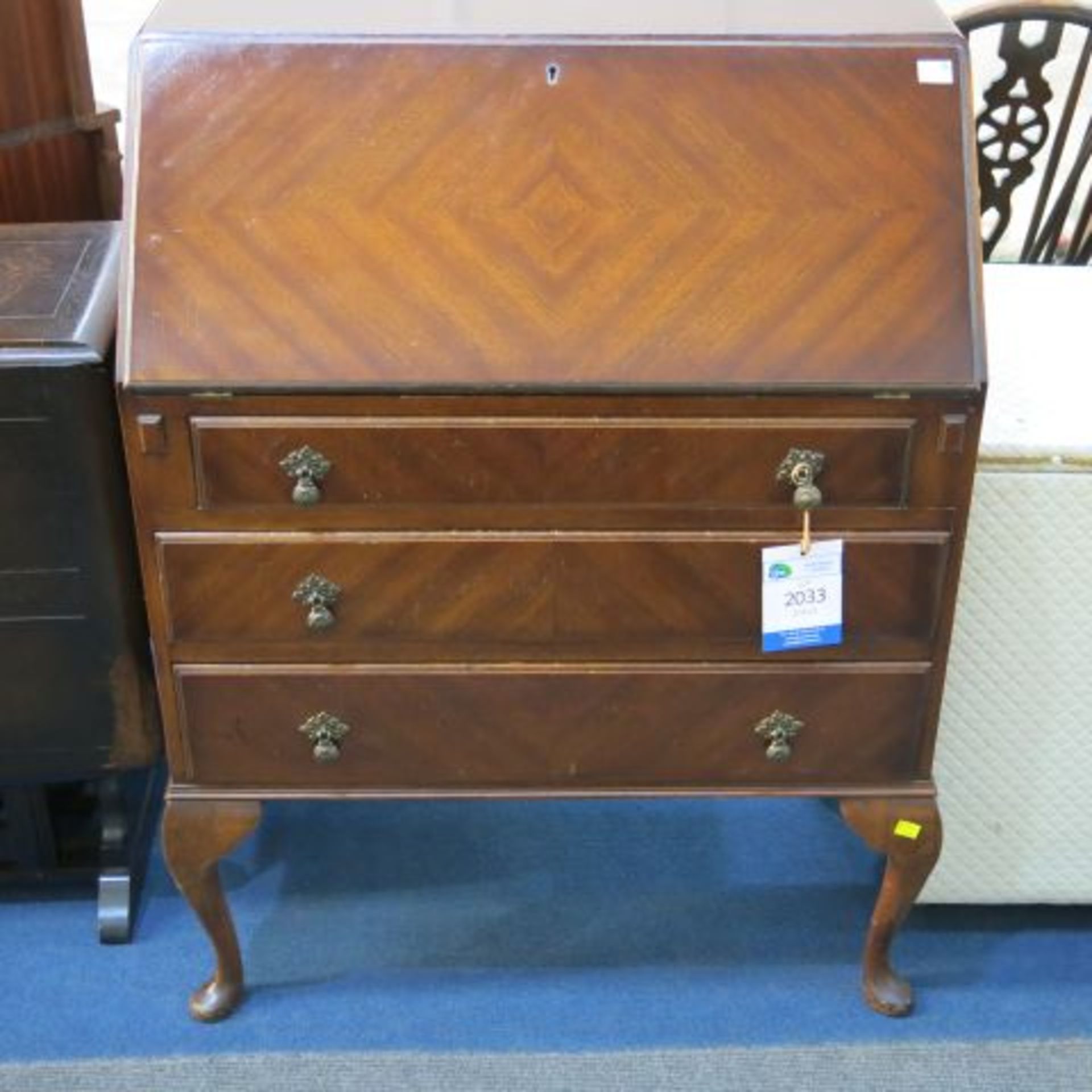 A Fitted Mahogany Writing Desk with three drawers on Cabriole Legs. The drawers each have two Tear