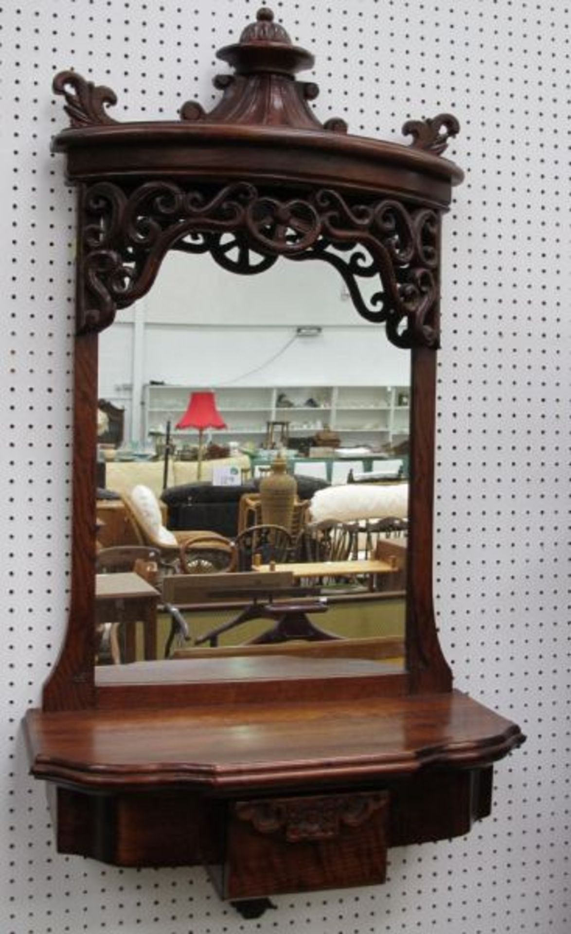 An Ornate Oak Wall Hanging Hall Mirror with Shelf and Single Drawer.  (est. £30-£50)