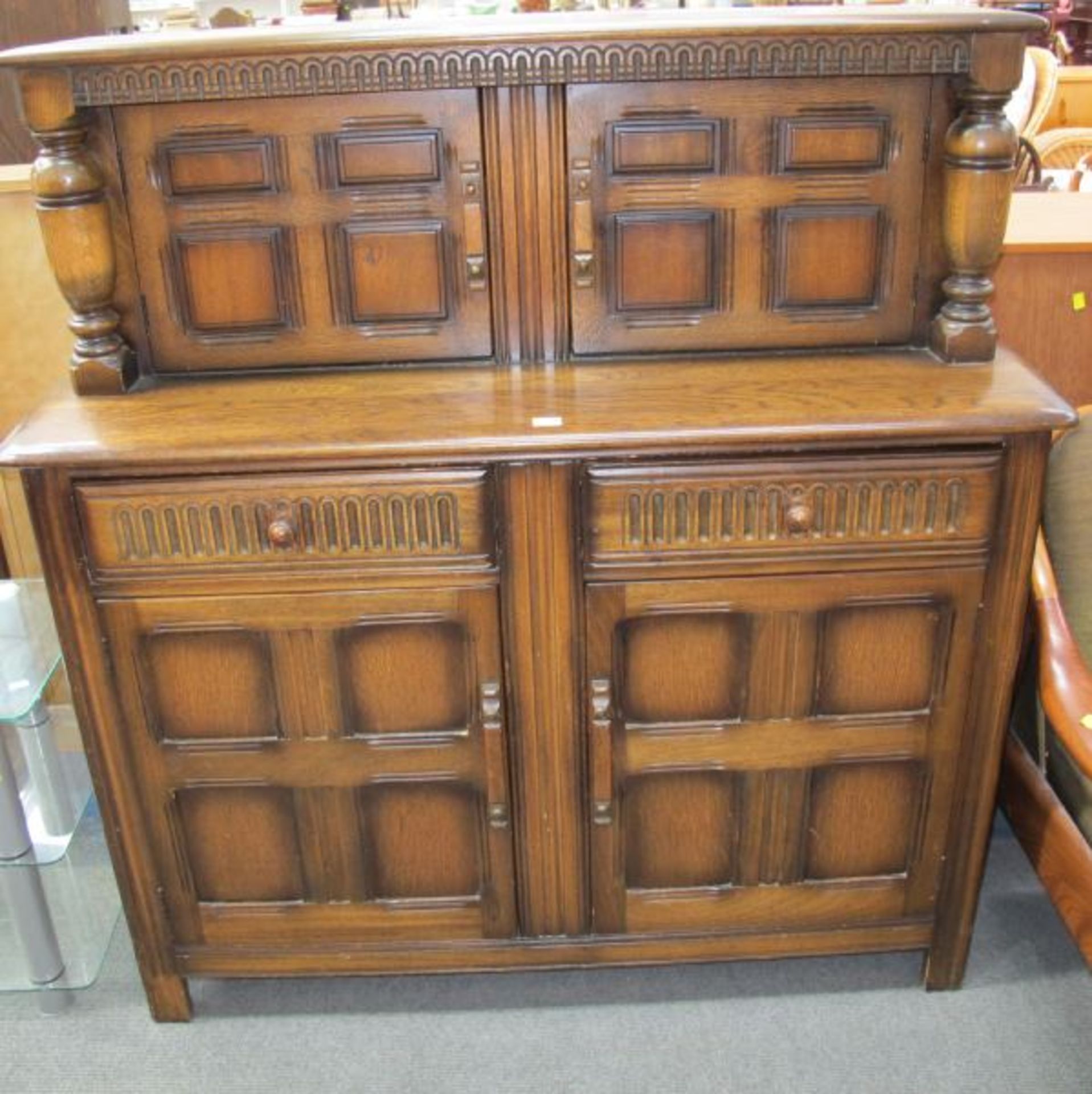 A Reproduction Oak ''Court'' Cupboard/Sideboard with Carved Panel Cupboard Doors and Drawers.
