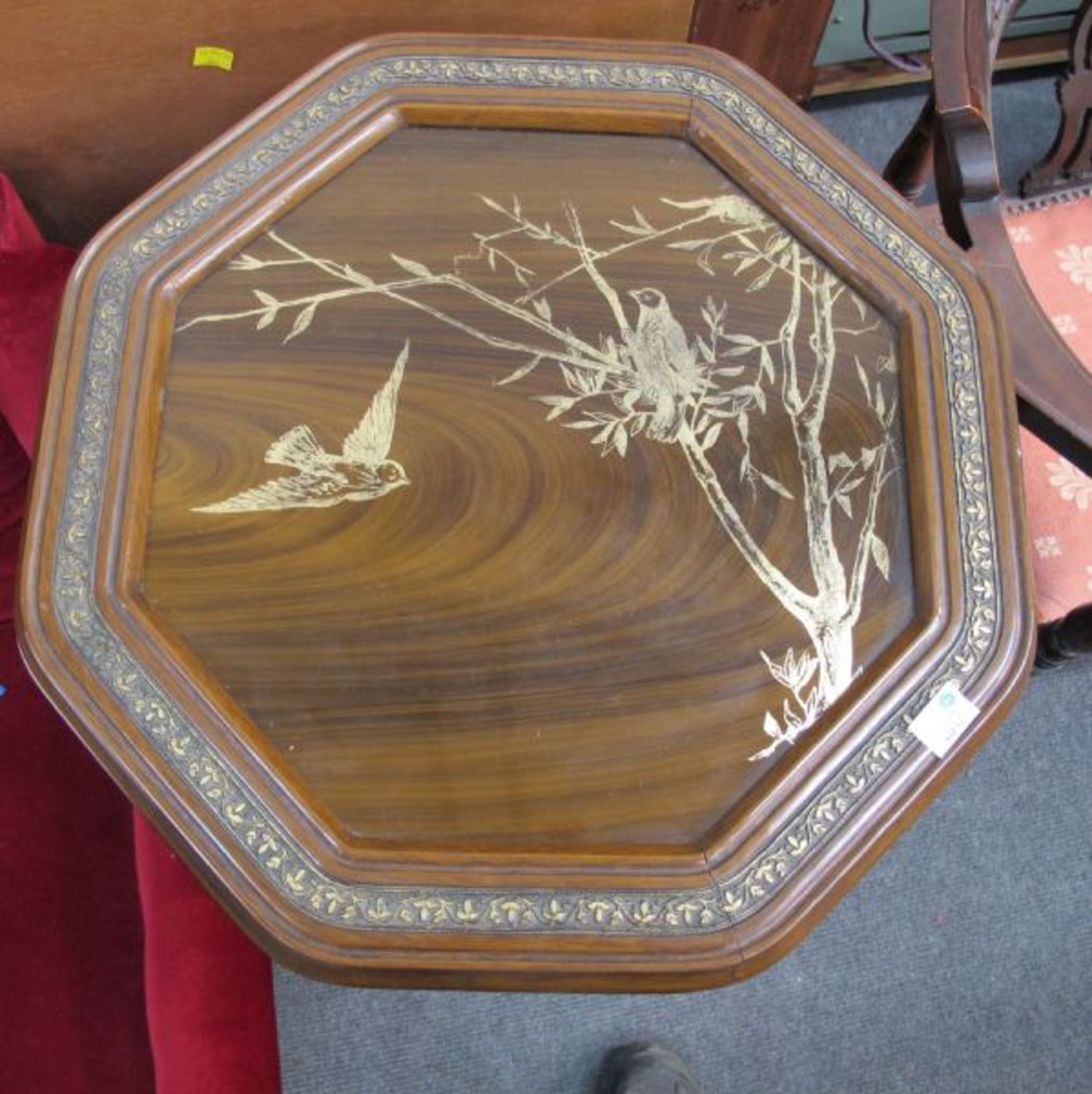An Oriental Octagonal Wine Table with Under Tier.  Both Tiers have a well defined continuous Leaf