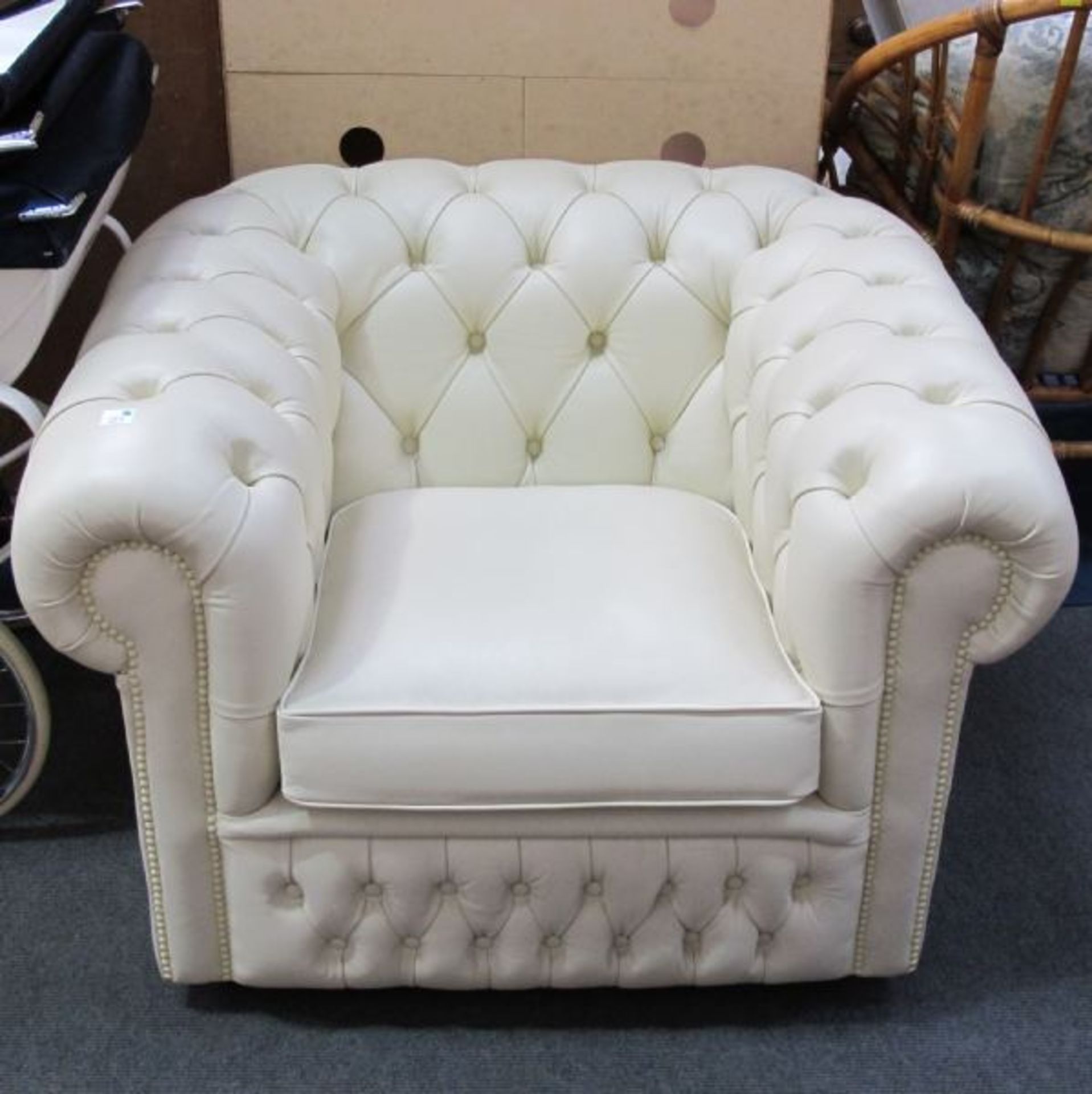 A Cream Leather Chesterfield Type Armchair. (est. £50-£80)