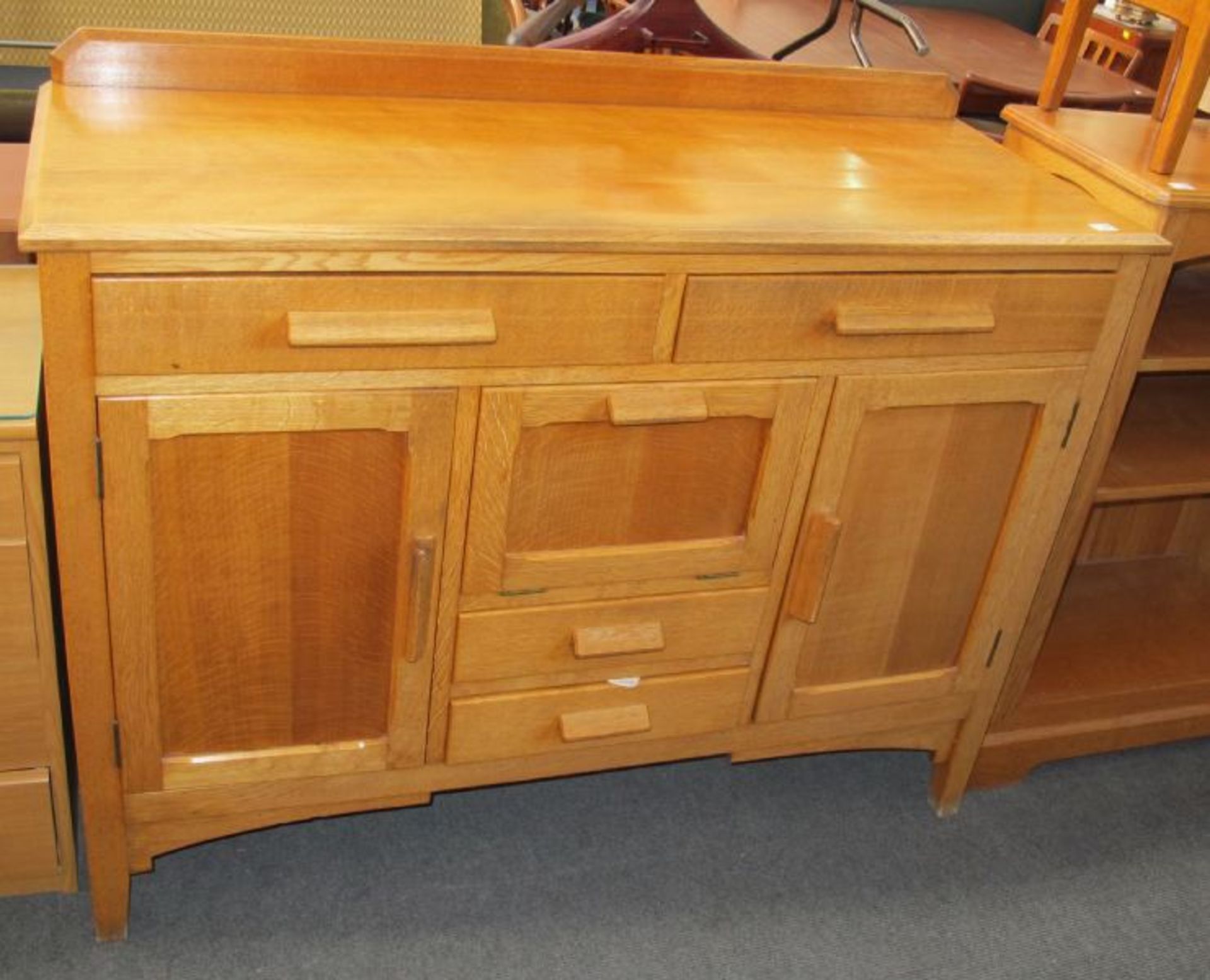 A Light Oak Sideboard with Various Cupboards and Drawers.  125cms.  (est. £40-£70)