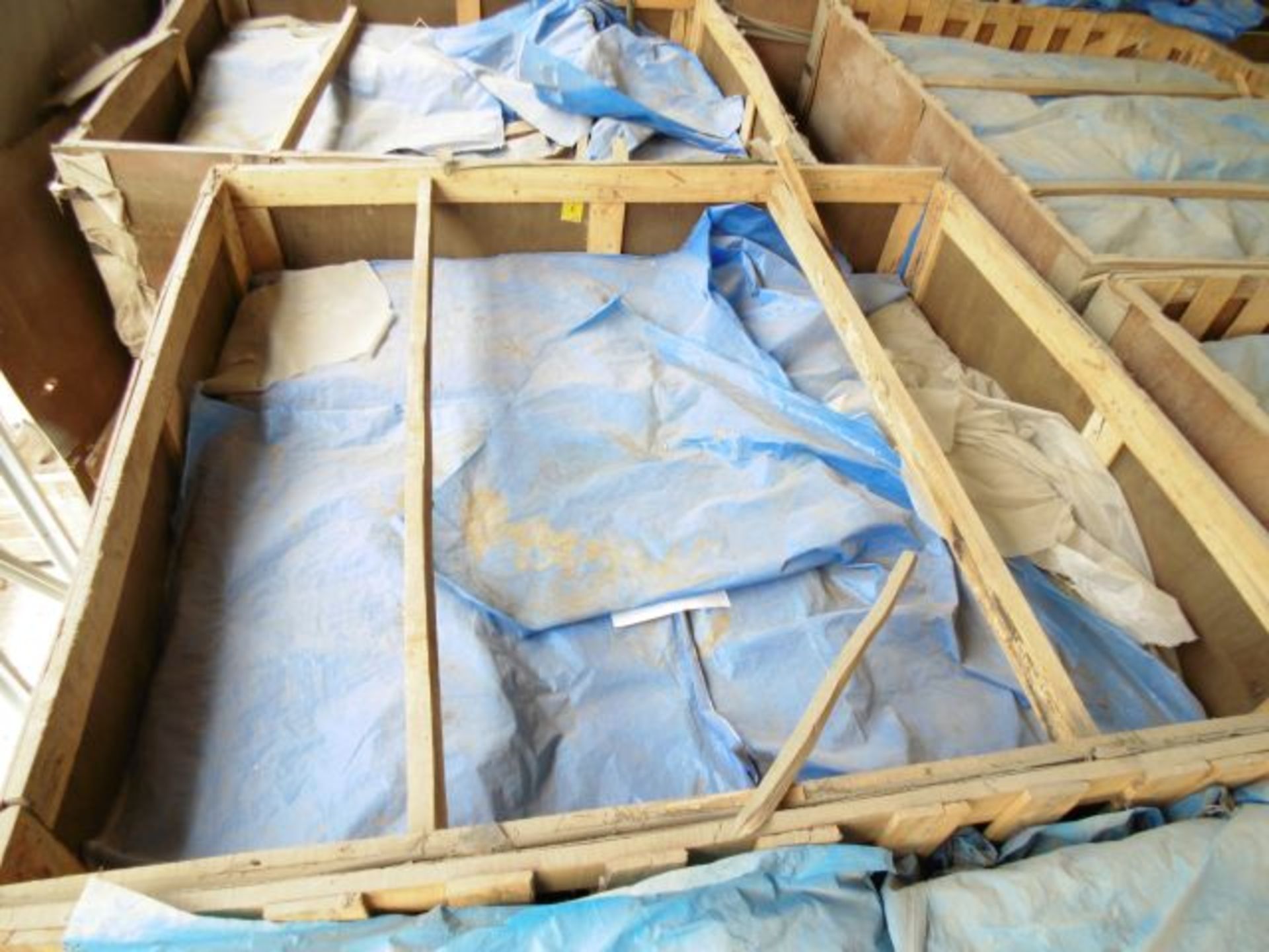 Large crate of bagged lightly resin bonded mattress wool