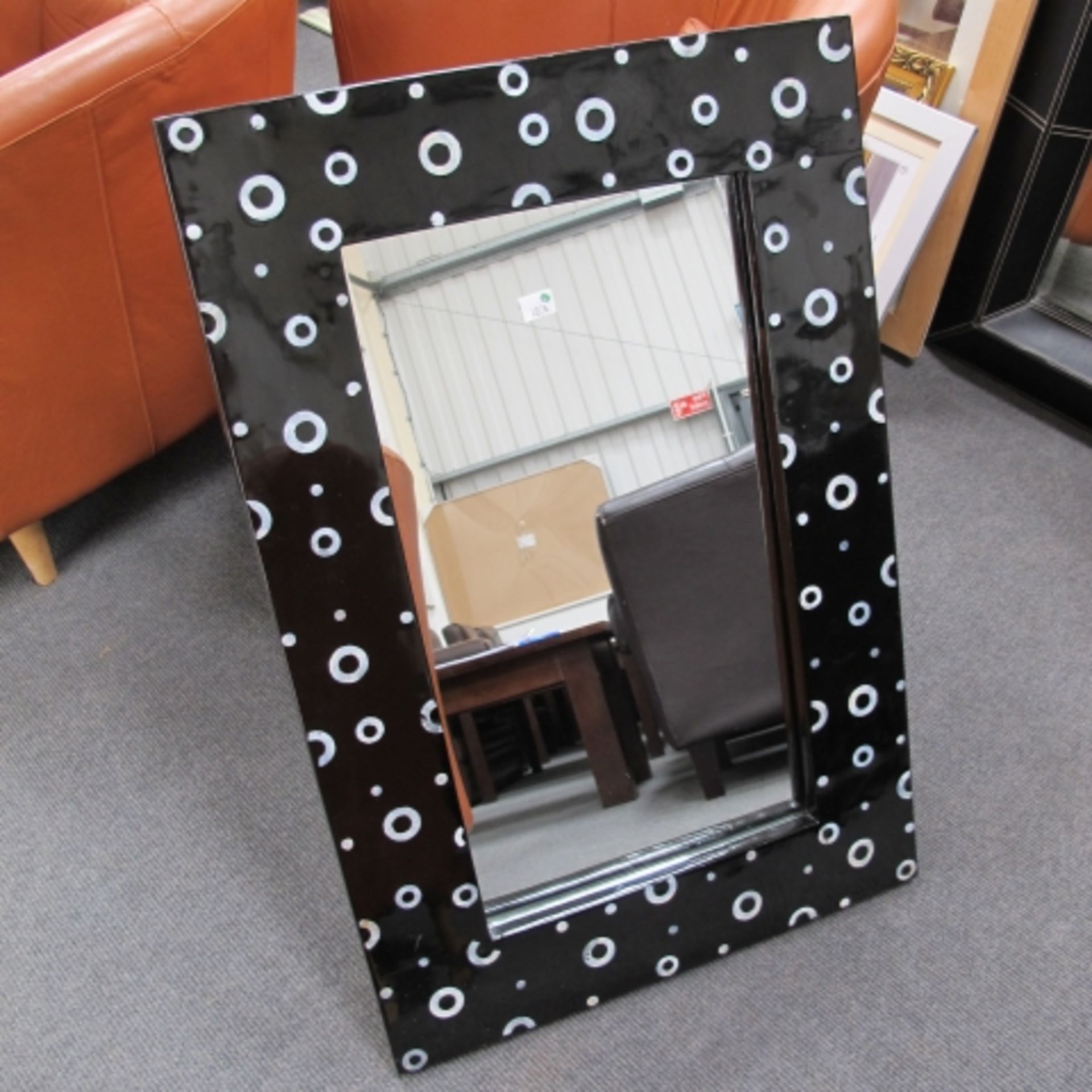 A large black faux leather covered frame wall mirror 90 x 77 cm overall and another decorative black
