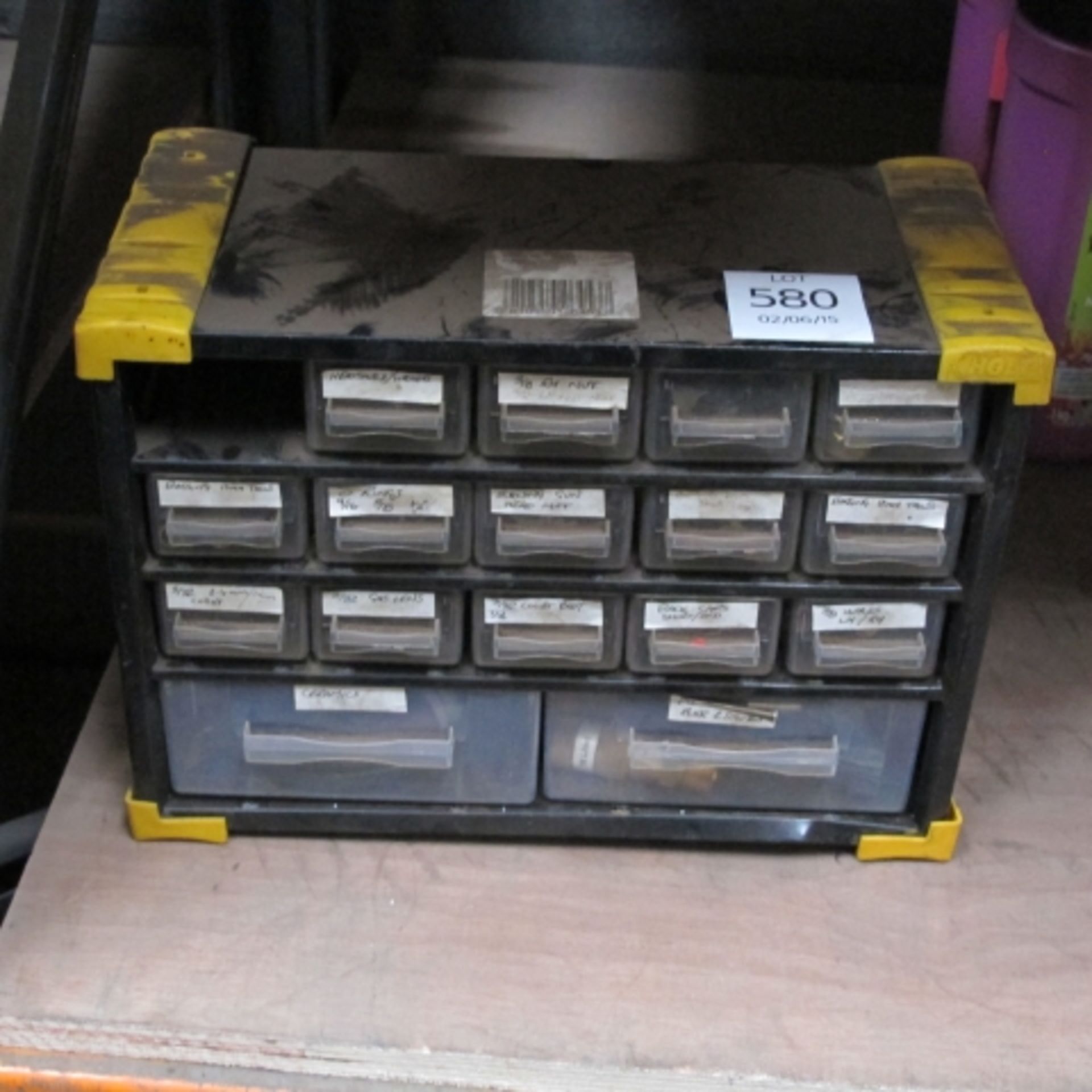 A small set of plastic drawers containing welding accessories