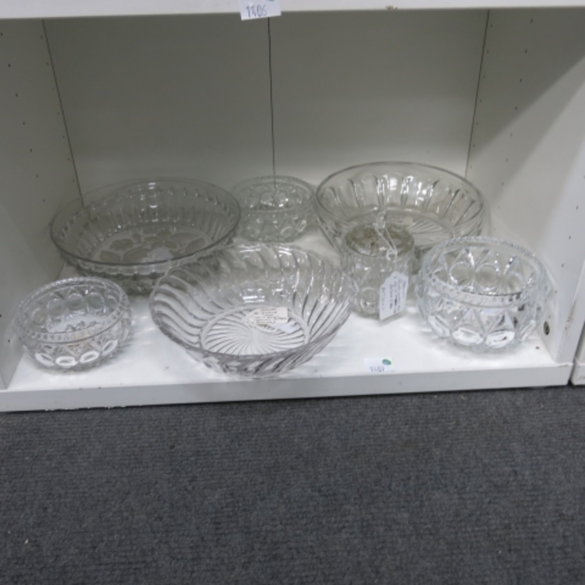 Lot containing four shelves of cut glass bowls, large, small, biscuit jar, candlestick holders,