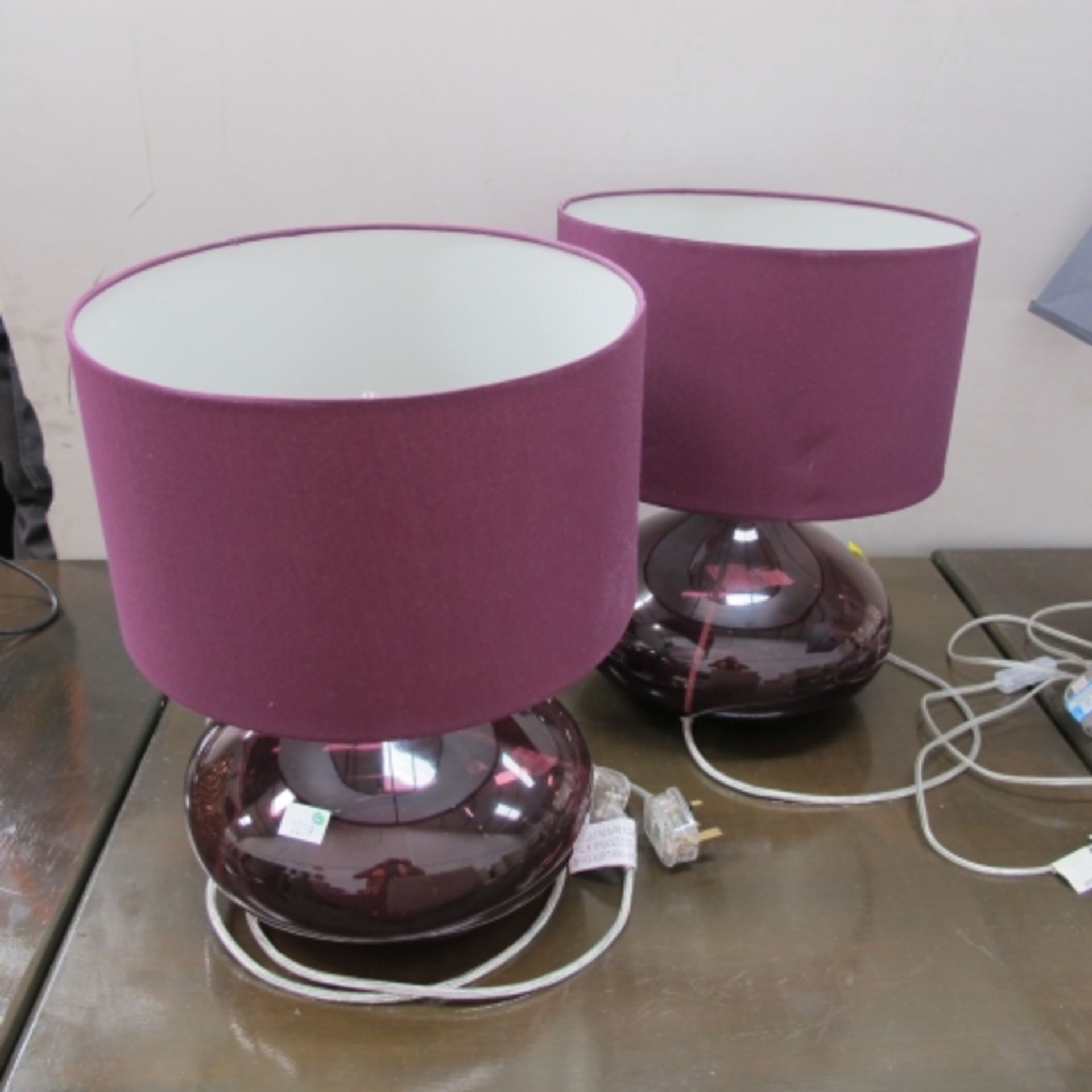 A pair of bulbous amethyst glass table lamps with shades (est. £20-£30)