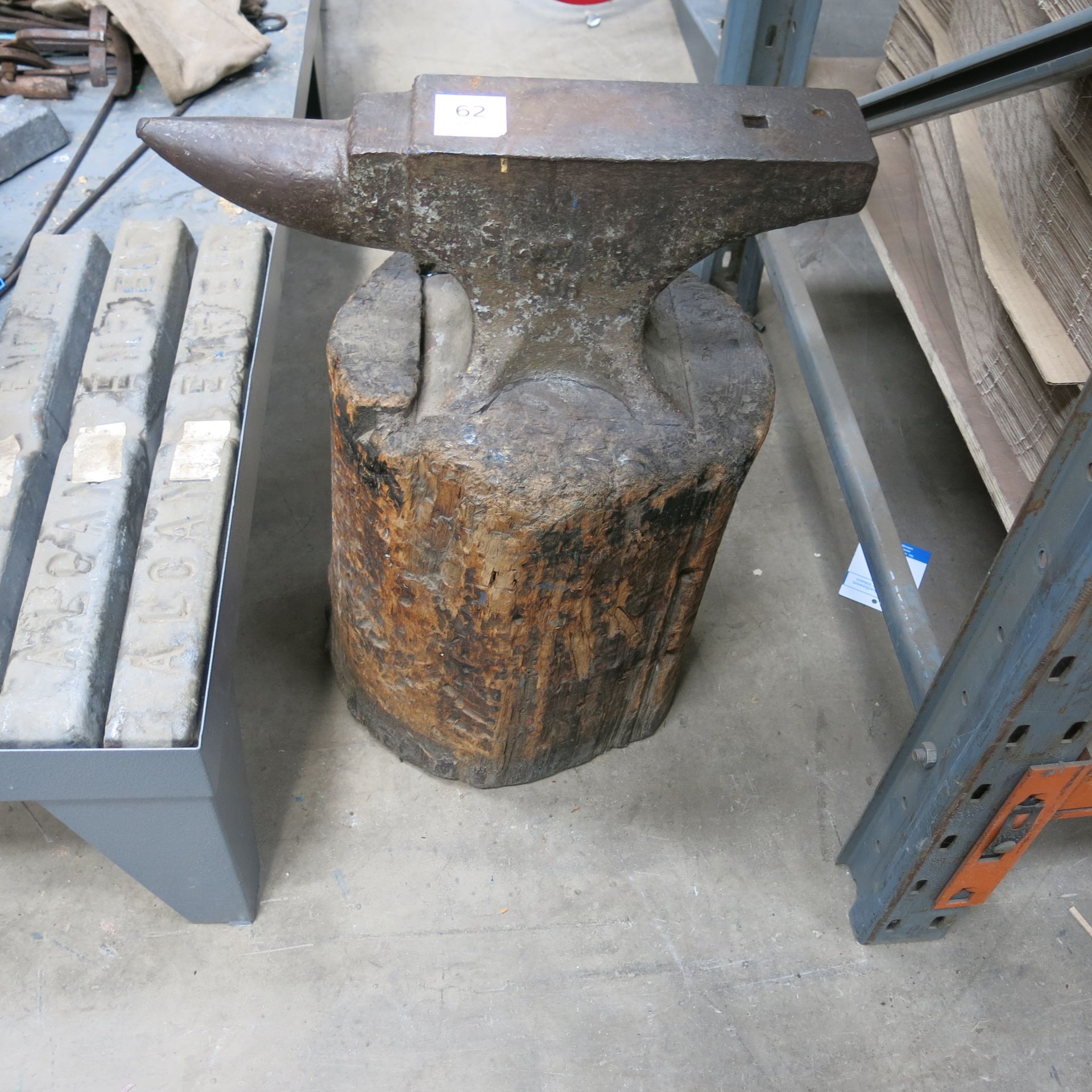 * An anvil on a wooden mount