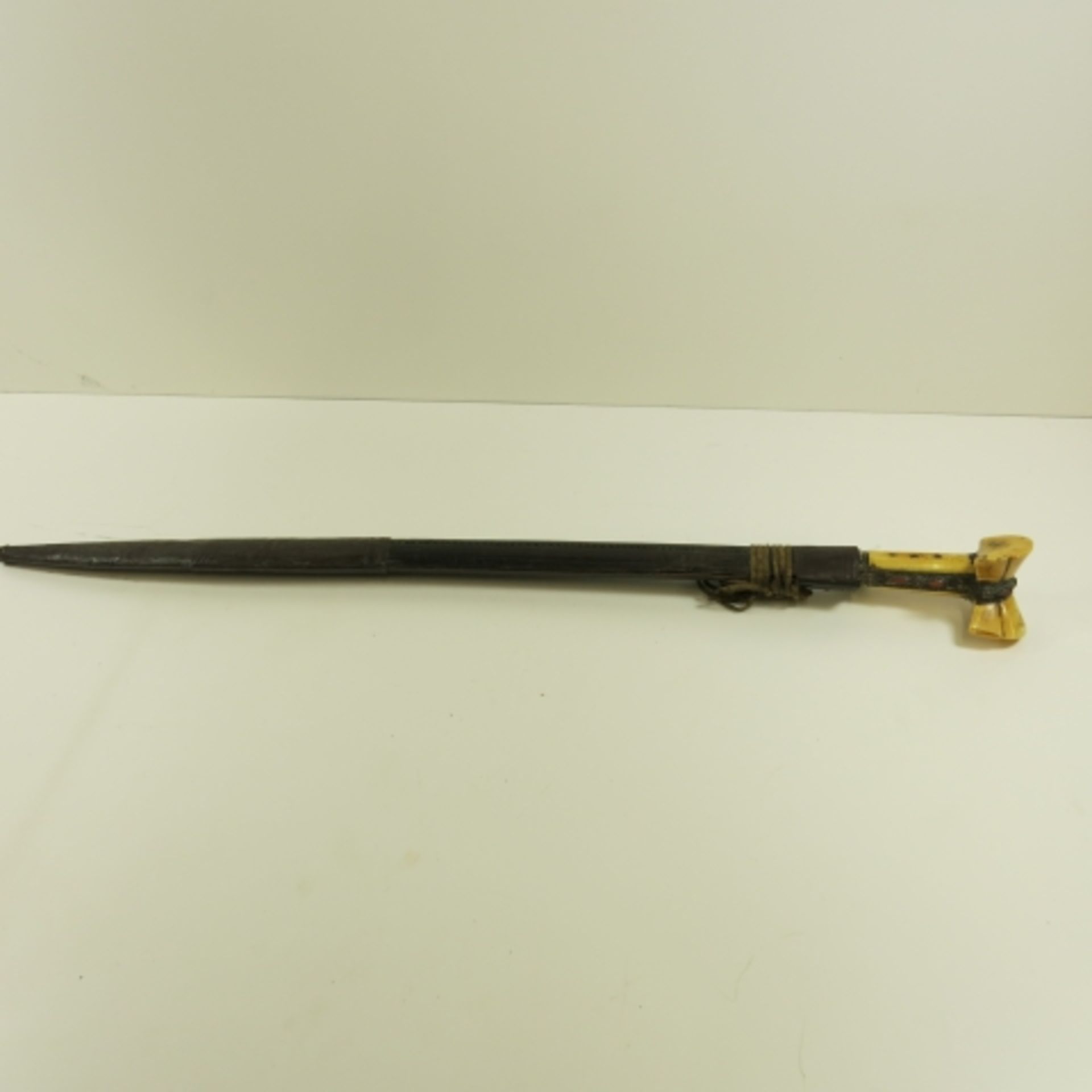 A Turkish Yataghan with bone handle decorated with metalwork and coral. The blade engraved