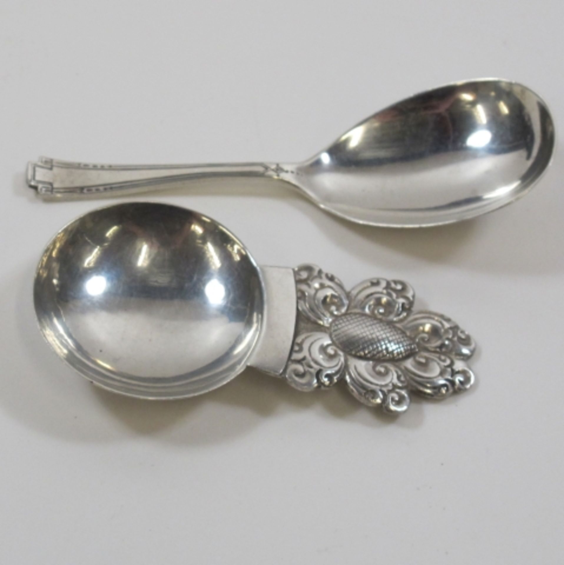 2 x Caddy spoons, 1 x Art Deco (1932) and 1 x marked SS (tests as Silver) (est. £40 - £60)