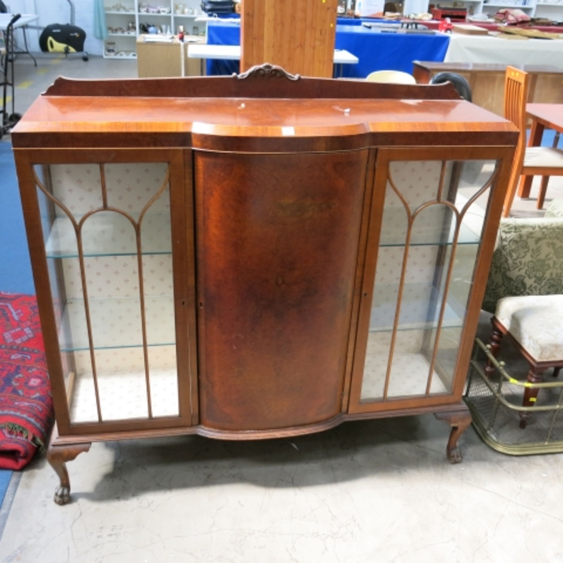 A tall part bow fronted walnut display cabinet with panel and glazed doors, 135cm (est. £25-£50)