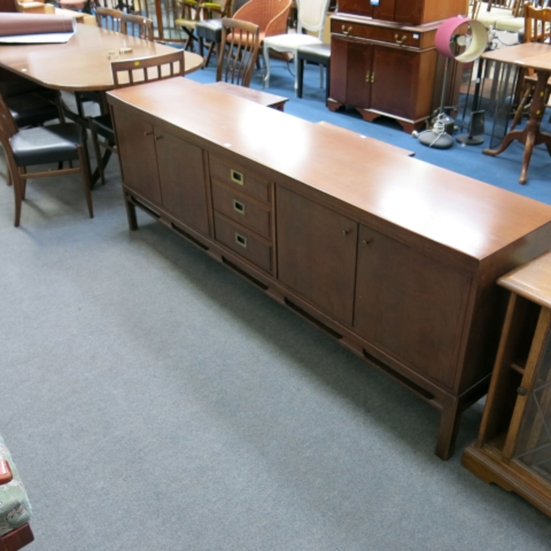 A 1960s walnut finish dining suite comprising pedestal table with inset folding leaf (240cm