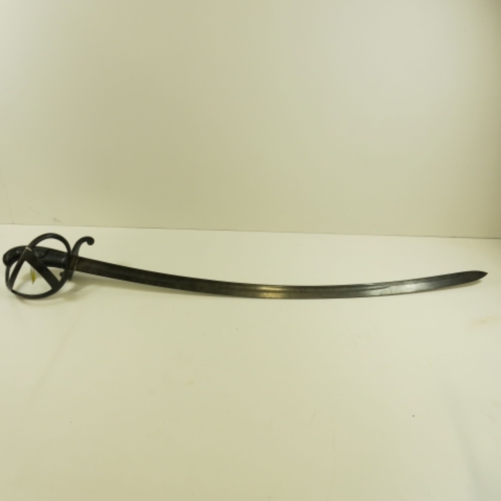 Early 20th century German Cavalry Sword, open basket with wooden grip. 90cm curved blade with