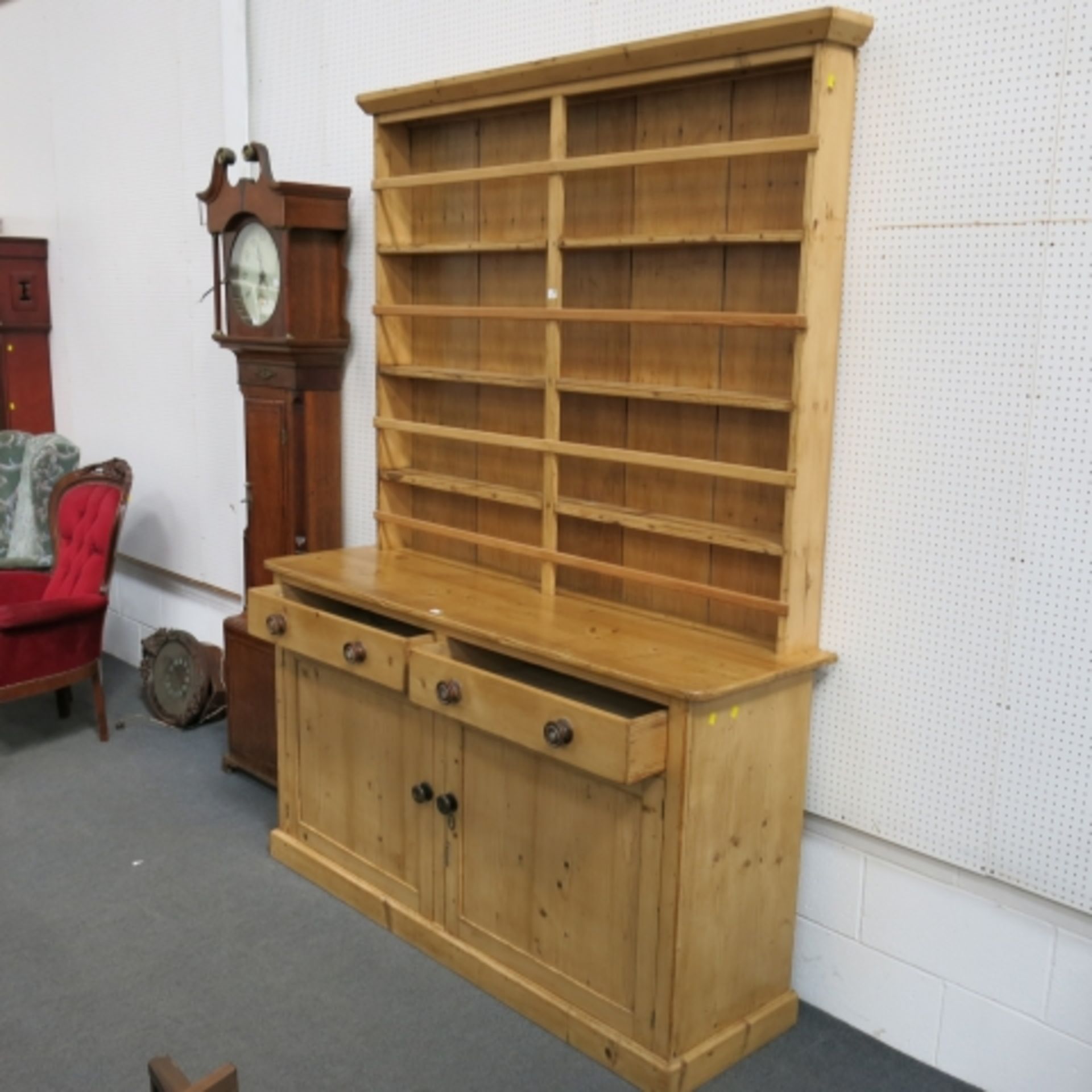 A Victorian stripped and polished pine 'Welsh' dresser with large delft rack over cupboards and