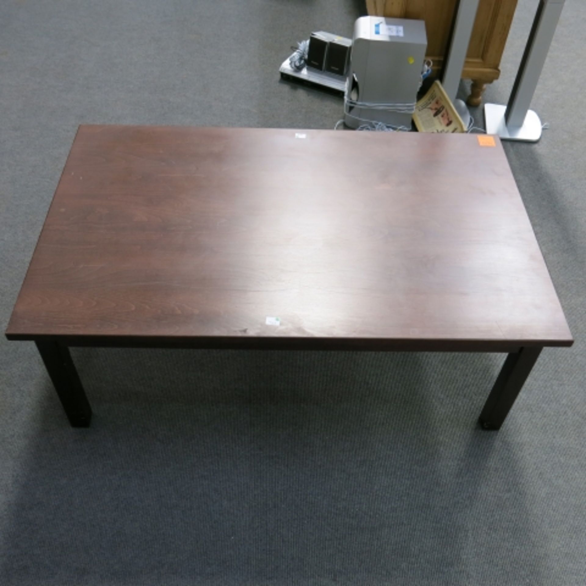 A large rectangular mahogany finish office coffee/magazine table. 122cm x 77cm (est. £20-£30)