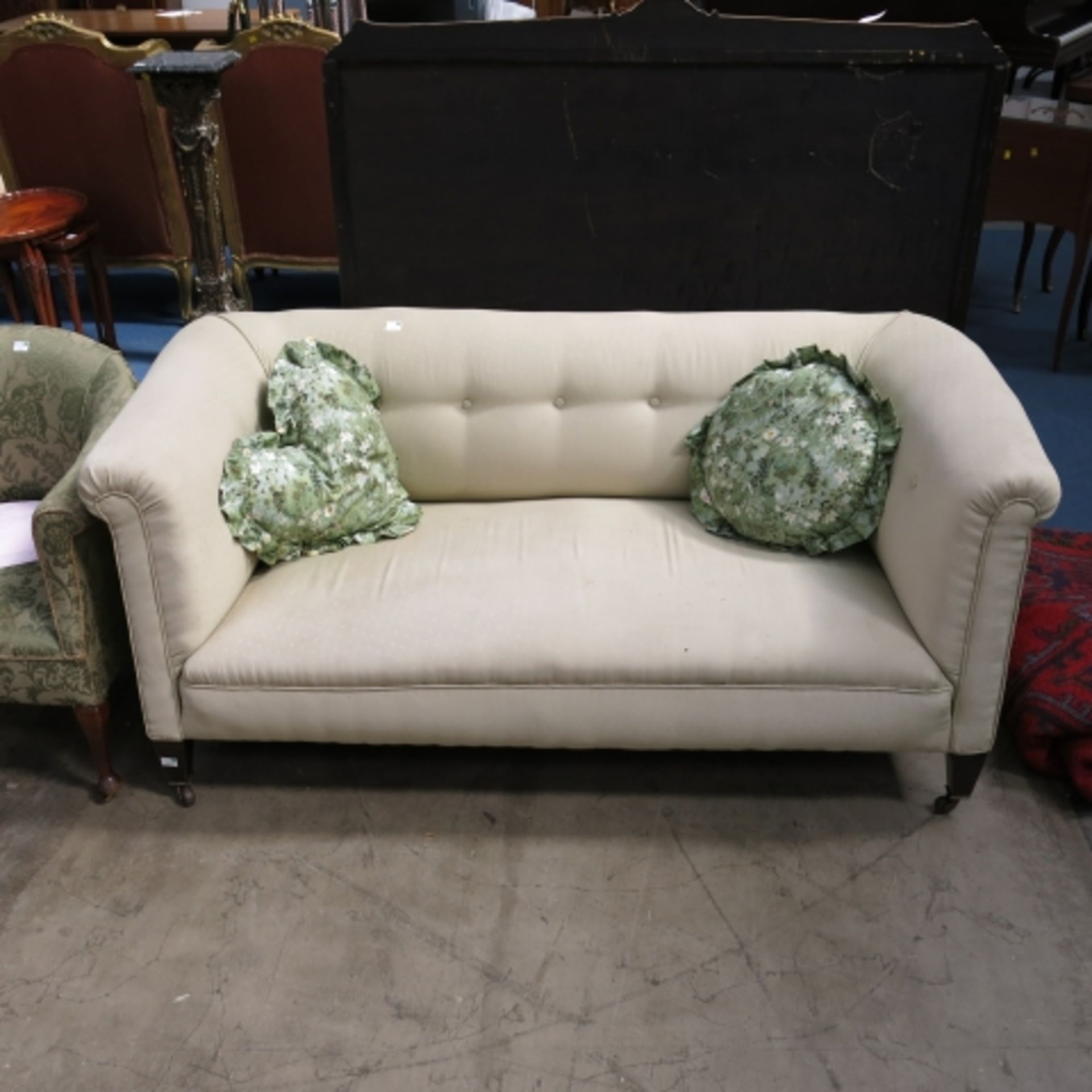 An early 20th century button back Chesterfield type sofa together with a large Ottoman cum day