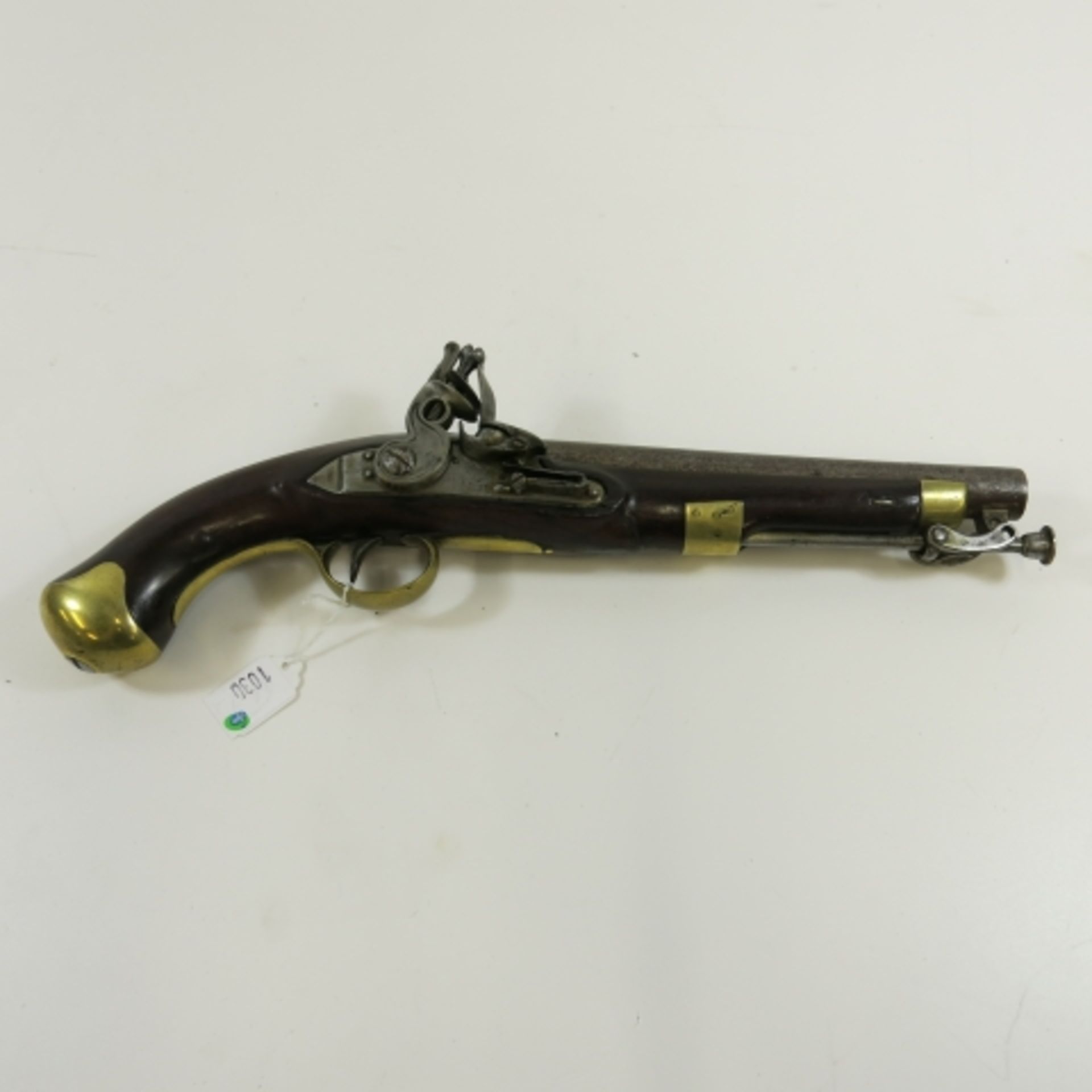 A Flintlock Pistol Newland Birmingham. 1 -75 caliber smooth bore pistol with steel stirrup ramrod