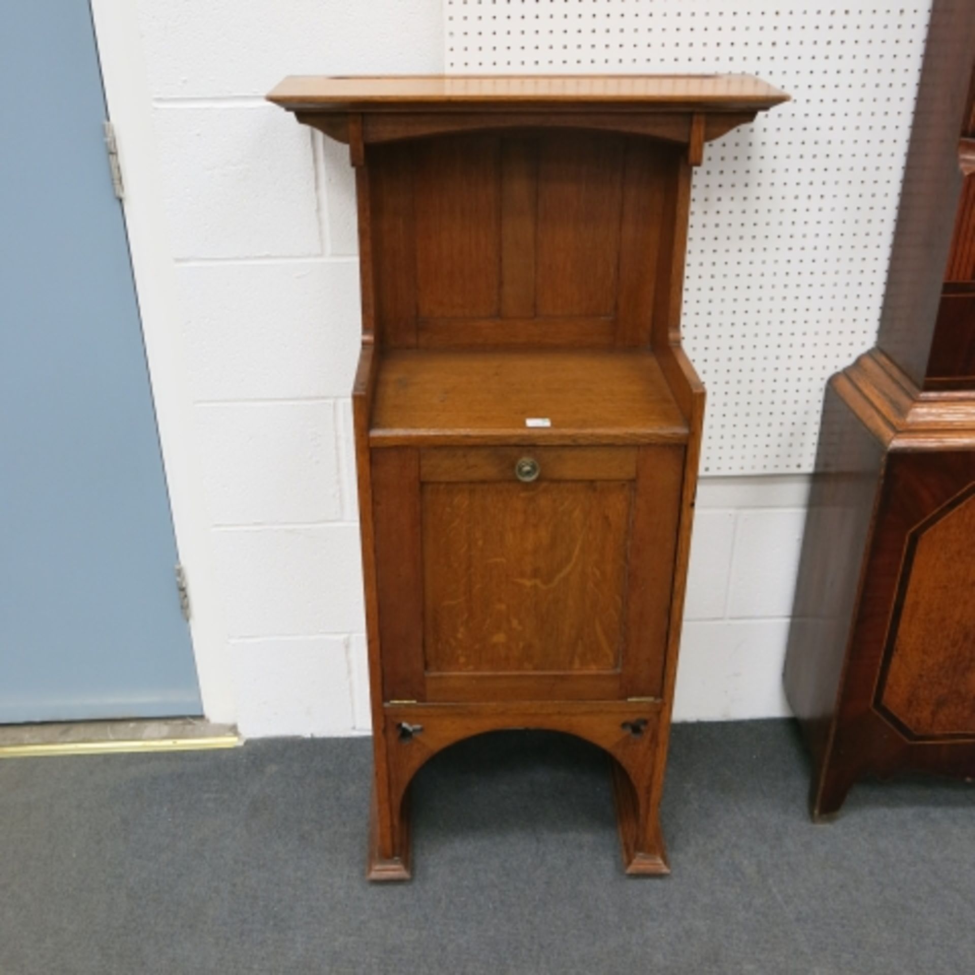 An Arts & Crafts oak narrow side cabinet with hinged single door. 63cm. (est. £40-£80)