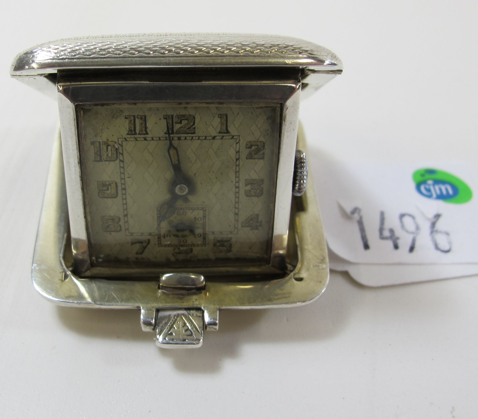 A Silver Cased Small Travelling Watch with Engine Turned Decoration, Birmingham 1931 (est £60-£100)