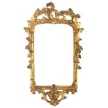 A rococo mirror frame, 18th Century,
carved and gilded, crest pierced acanthus leaf, at the sides