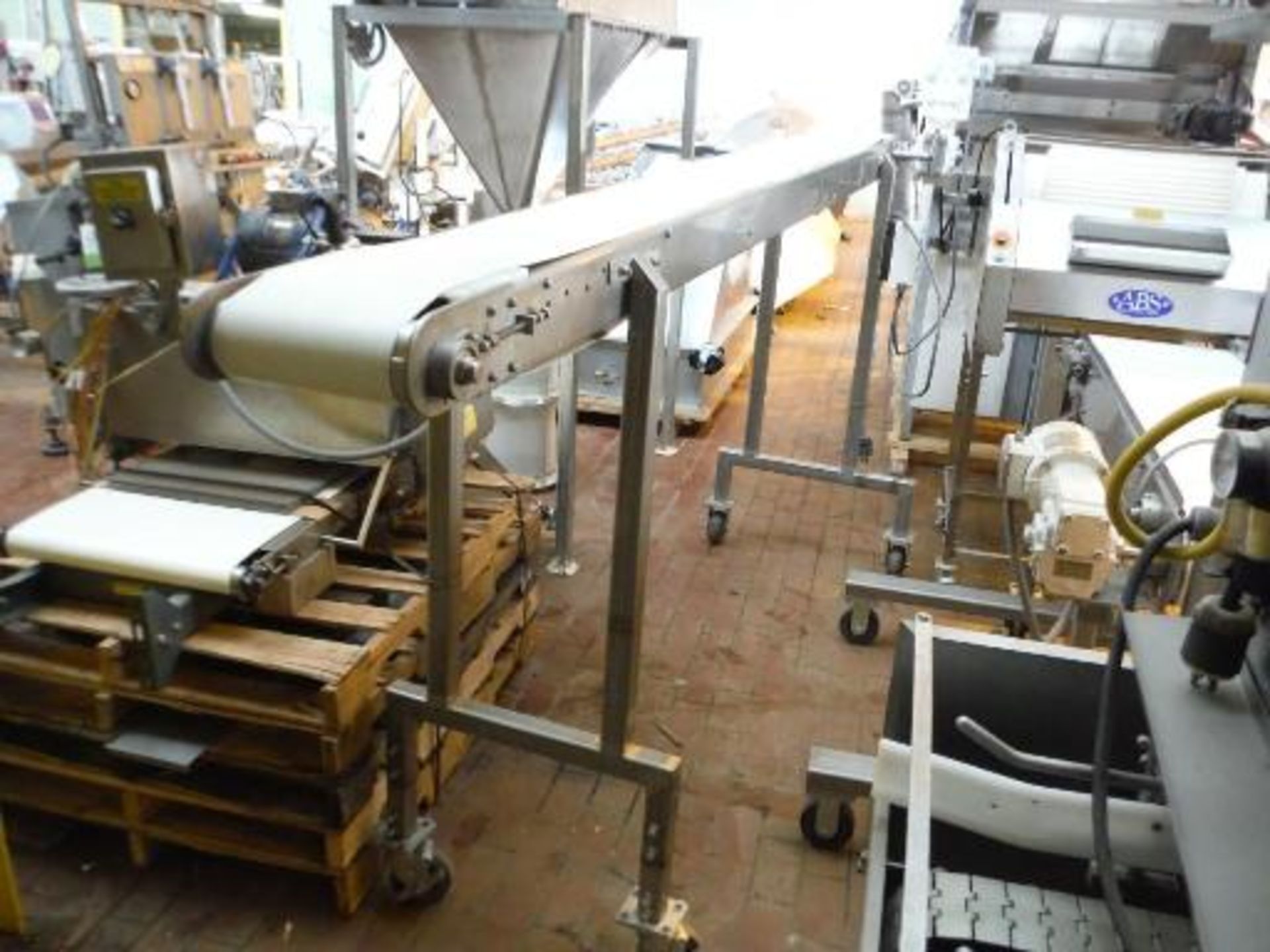 Transfer conveyor, 123 in. long x 10 in. wide x 53. in tall, SS frame, casters ***___   A Rigging