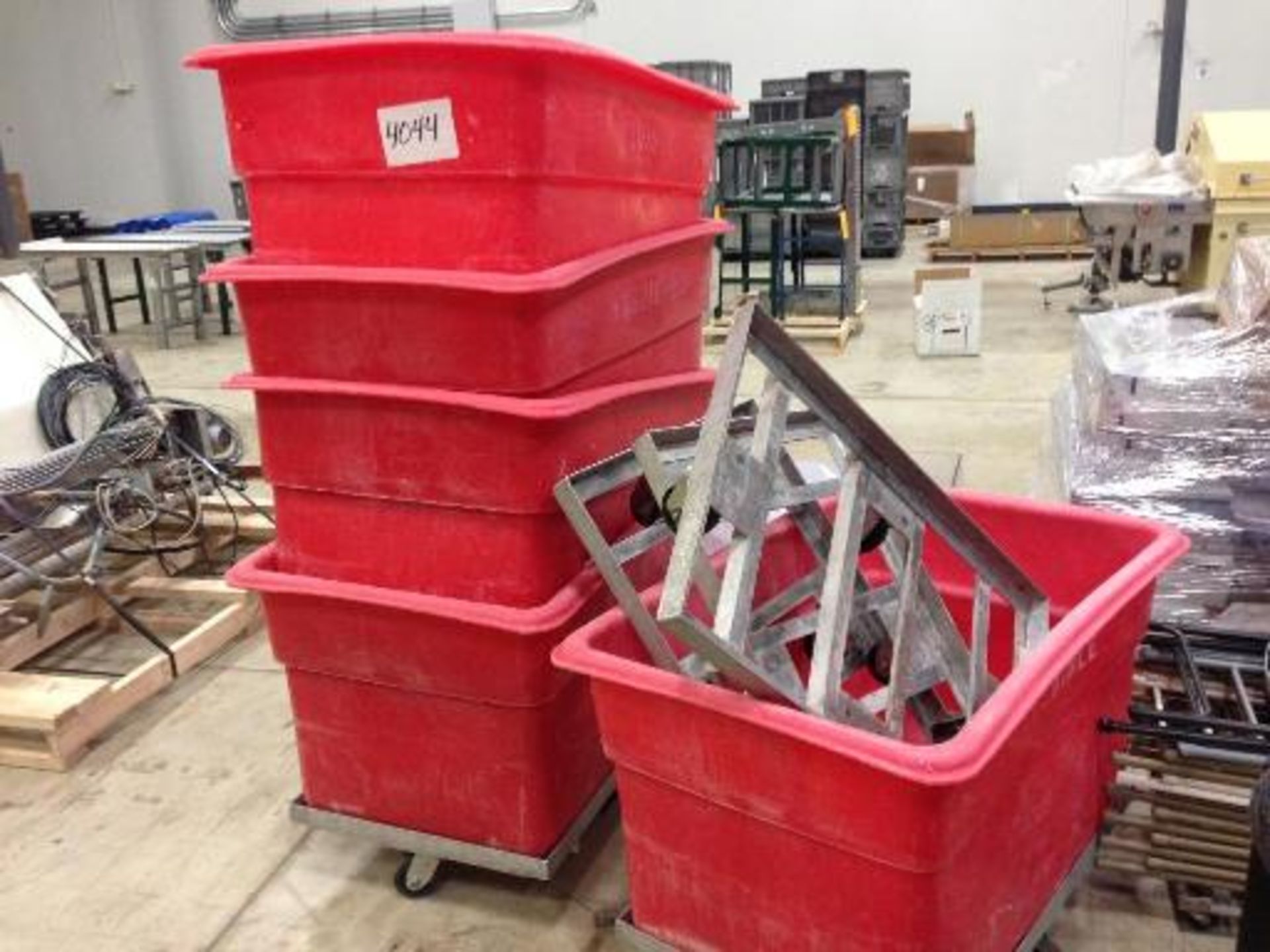 (5) red poly cart on wheels (LOT) This item located in Grand Rapids, Michigan **__ A Rigging Fee
