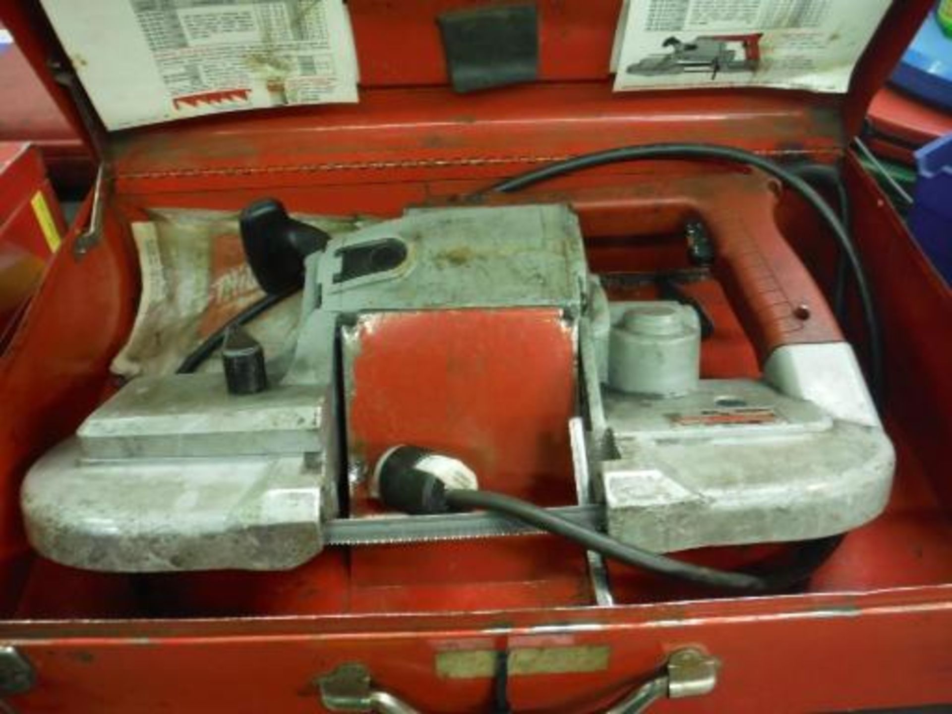 Milwaukee heavy duty portable electric band saw, 4 3/4 in deep cut w/ case, w/ extra blades. Located