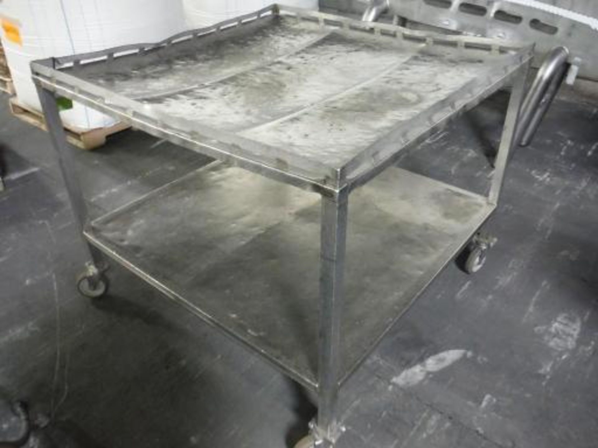 SS table, 46 in. long x 46 in. wide x 36 in. tall, 2 level, casters This item is located in