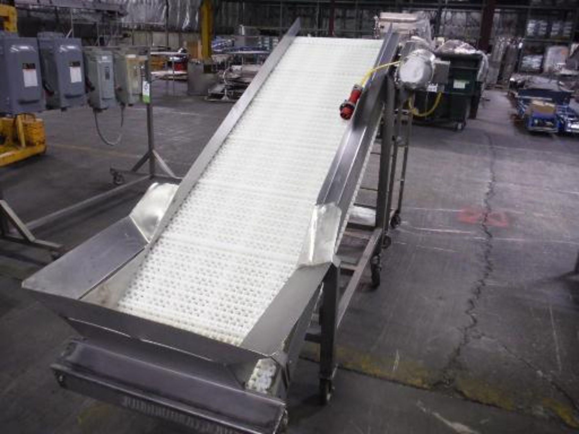 Incline conveyor, cleated plastic interlock belt, 84 in. long, 24 in. wide, 20 in. inlet, 54 in.