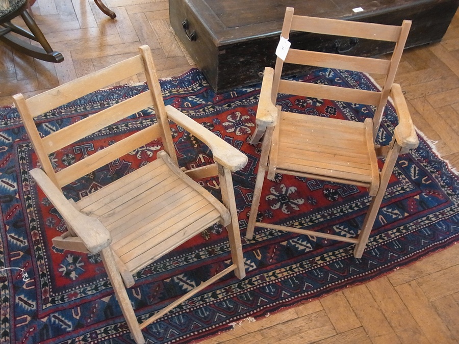 A pair of child's stained wood folding g