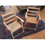 A pair of child's stained wood folding g