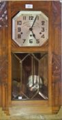 Carved oak wall clock inscribed "Ouvrier