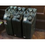Three large green petrol cans