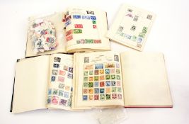 Three small albums of world stamps, some