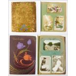 Two early 20th century postcard albums,