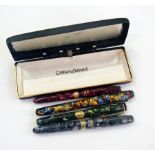 Three marbled Burnham fountain pens, wit